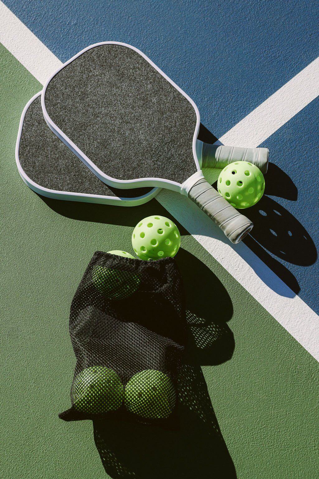 Pickleball paddle and ball on court at Court88